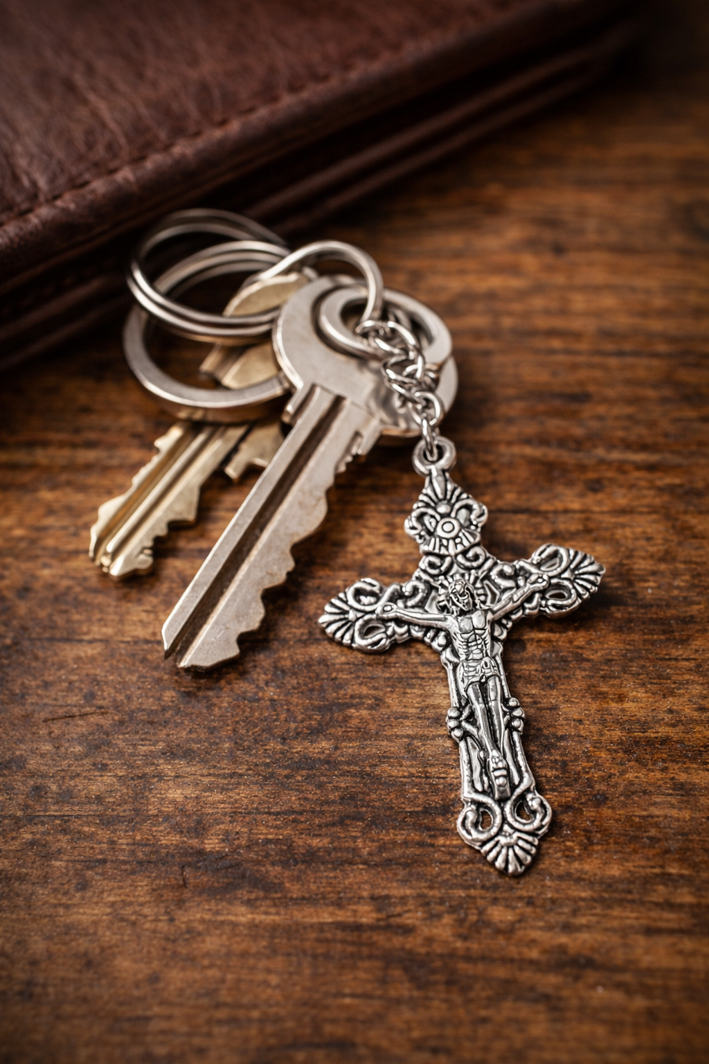 Religious crucifix keychain attached to keys for everyday Christian faith reminder