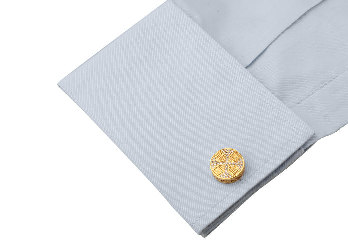 gold cross cufflinks worn with dress shirt