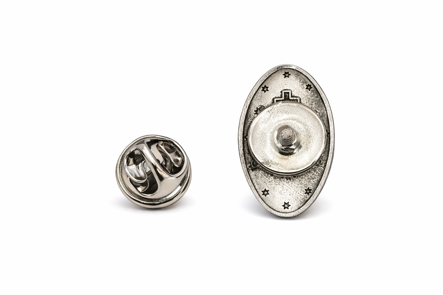 Silver metal badge or pin on a white background