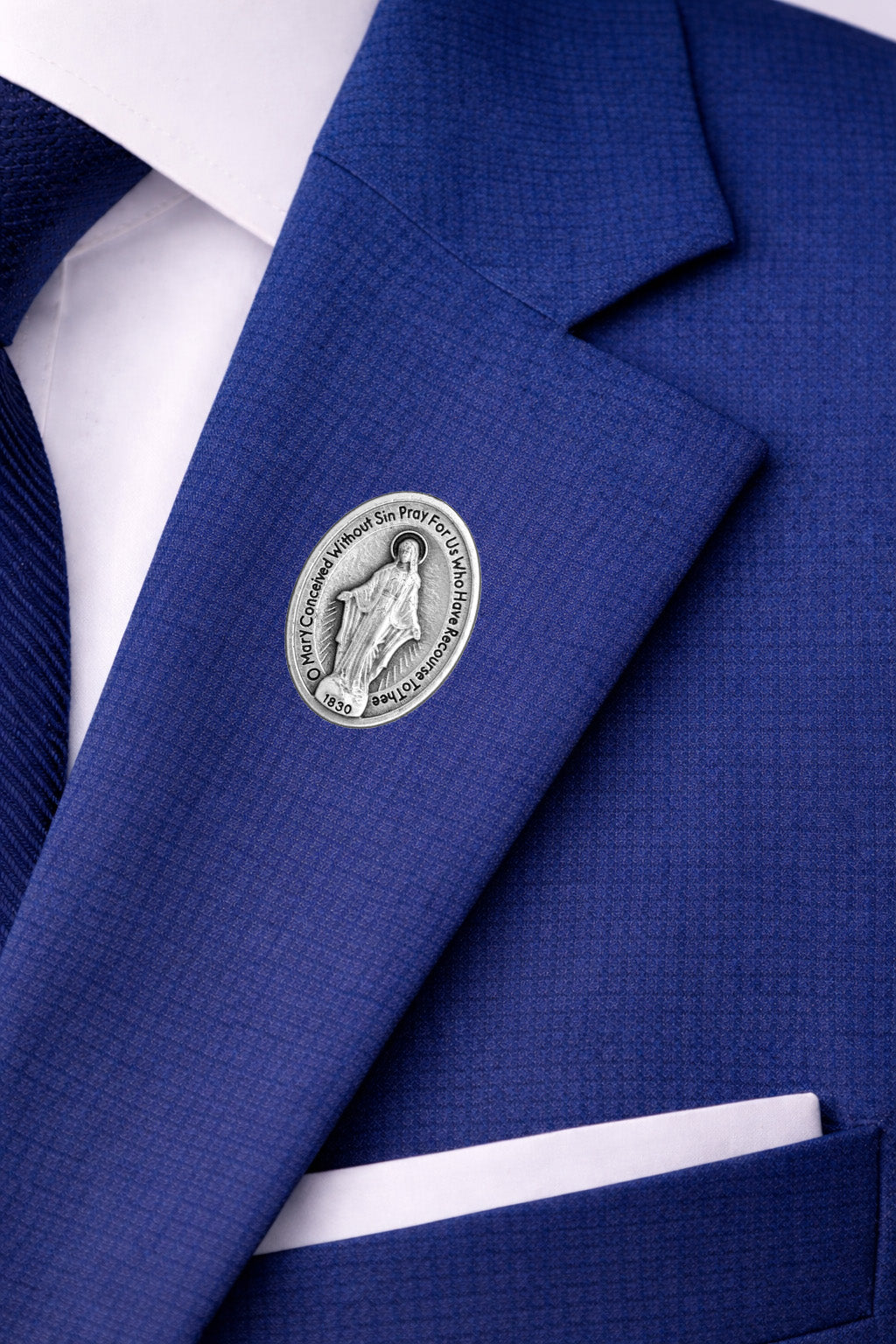 miraculous medal pin on jacket