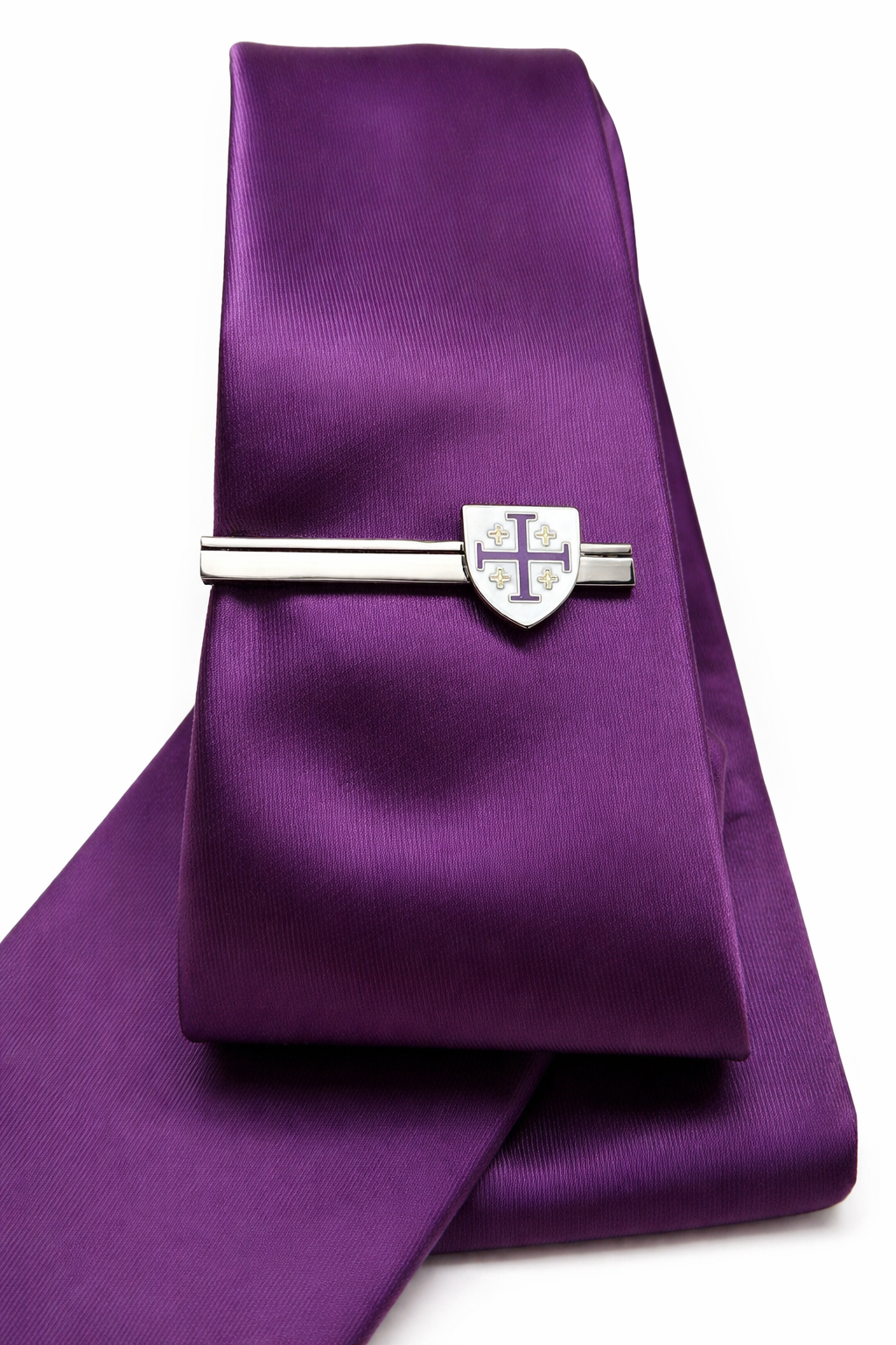 Purple tie with a silver tie clip on a white background