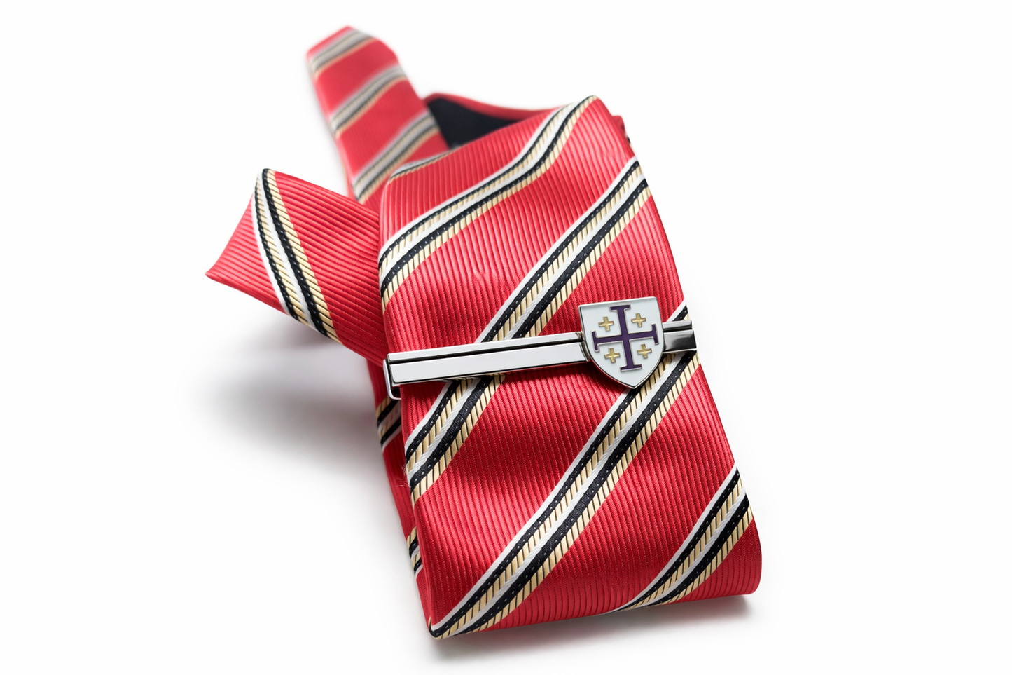 Red striped tie with a decorative clasp on a white background