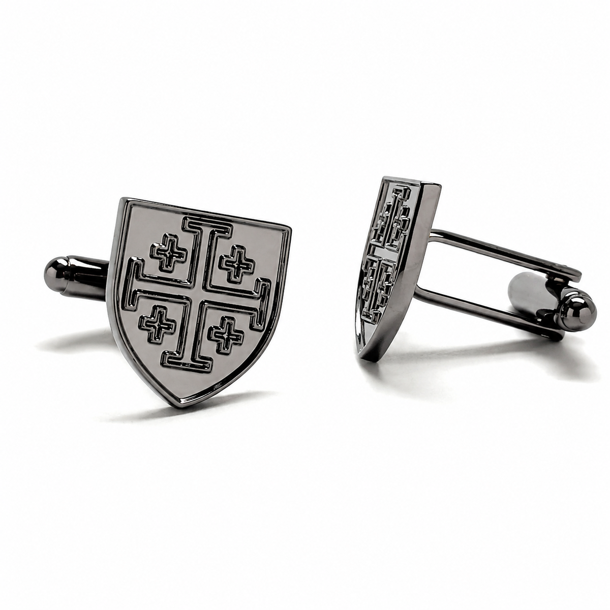 A pair of metallic gunmetal cufflinks shaped like a shield, featuring a black engraved cross pattern, displayed on a clean white background.