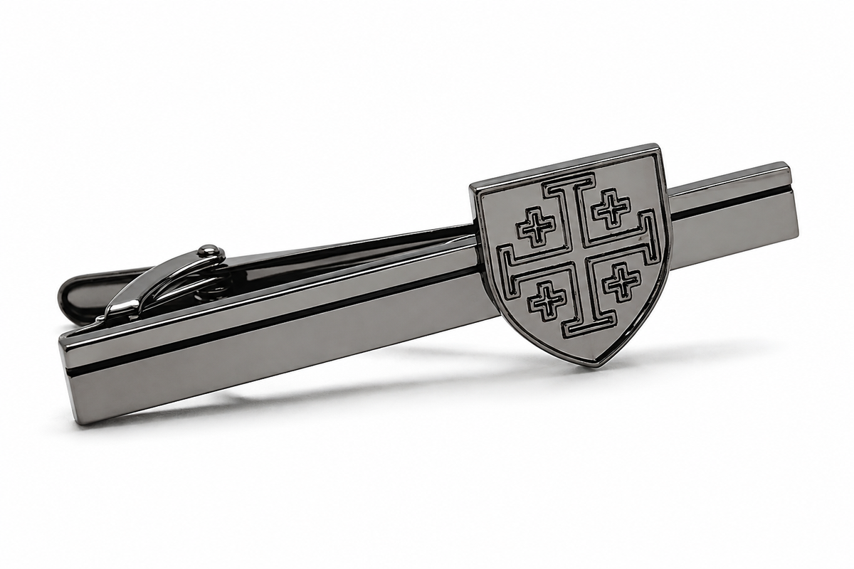 A dark gray metallic tie clip featuring a shield crest with four cross motifs, displayed on a clean white background.