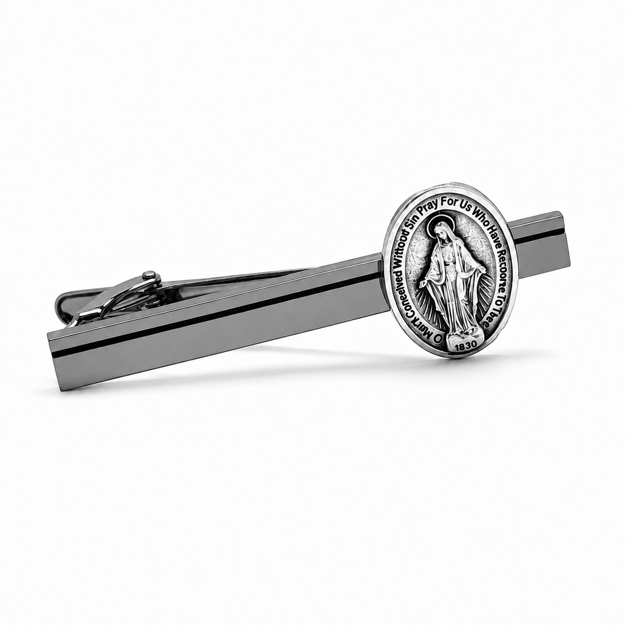 A silver-toned tie clip featuring a circular Miraculous Medal pendant with the Virgin Mary's image and the inscription 'DE OPE MARYI DEI GRATIA PRO VITAE SANCTIONIS', shown on a clean white background.