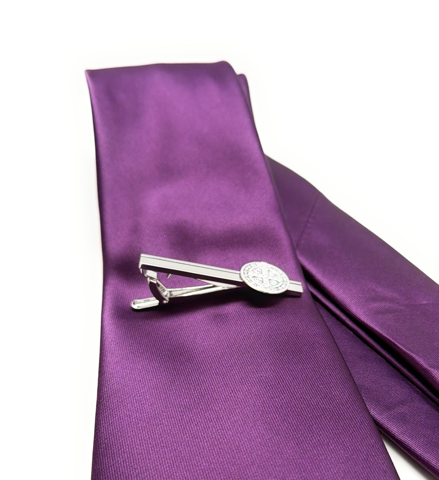 Purple tie with a silver clip on a white background side view