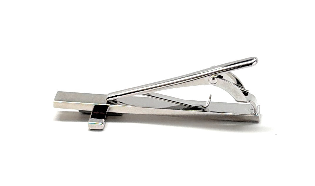 Silver tie clip on a white background