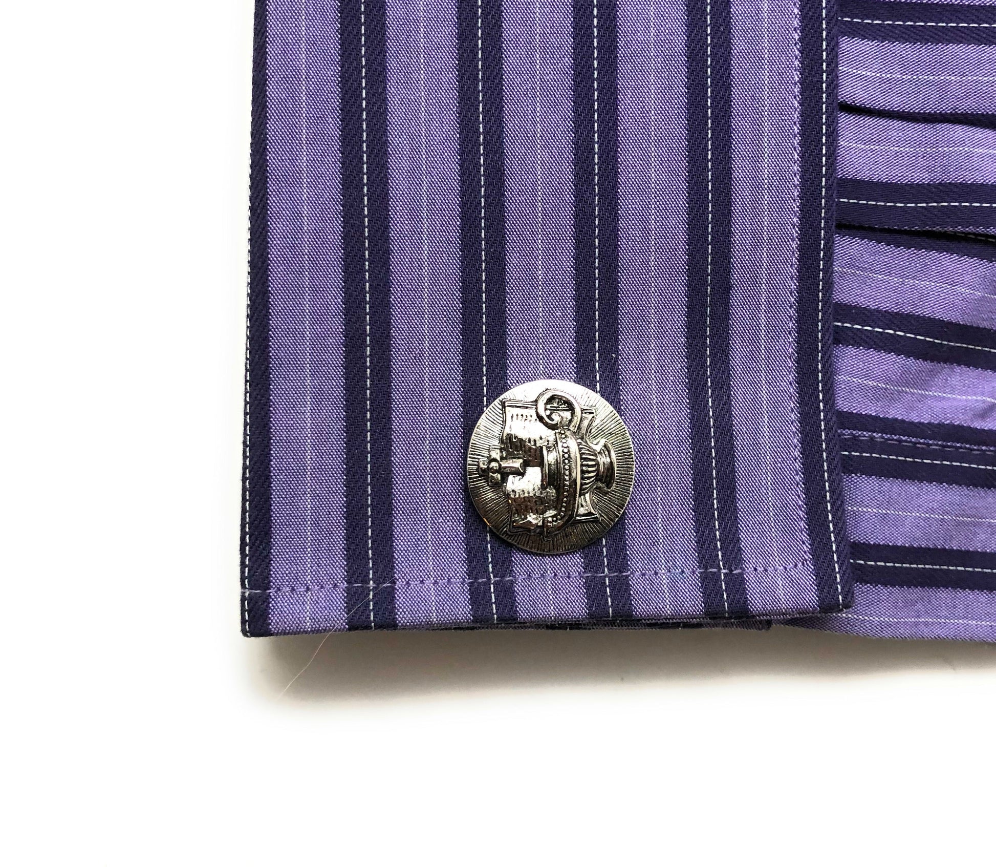 Close-up of a purple and navy striped shirt Ten Virgins oil lamp cufflinks Christian jewelry for men