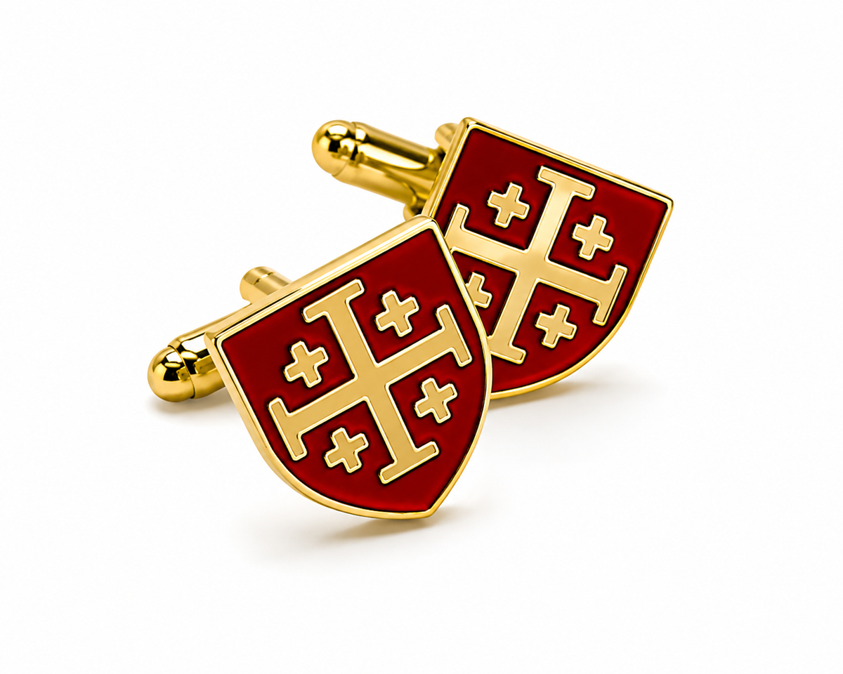 A pair of gold and red enamel cufflinks shaped like shields with a gold cross motif on a white background.