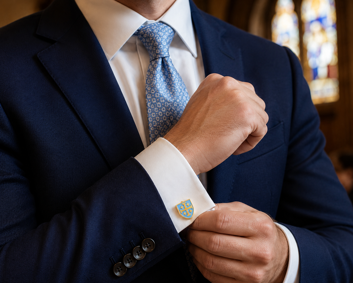 Gentleman wearing gold and light blue Jerusalem Cross cufflinks with a navy suit while attending church.