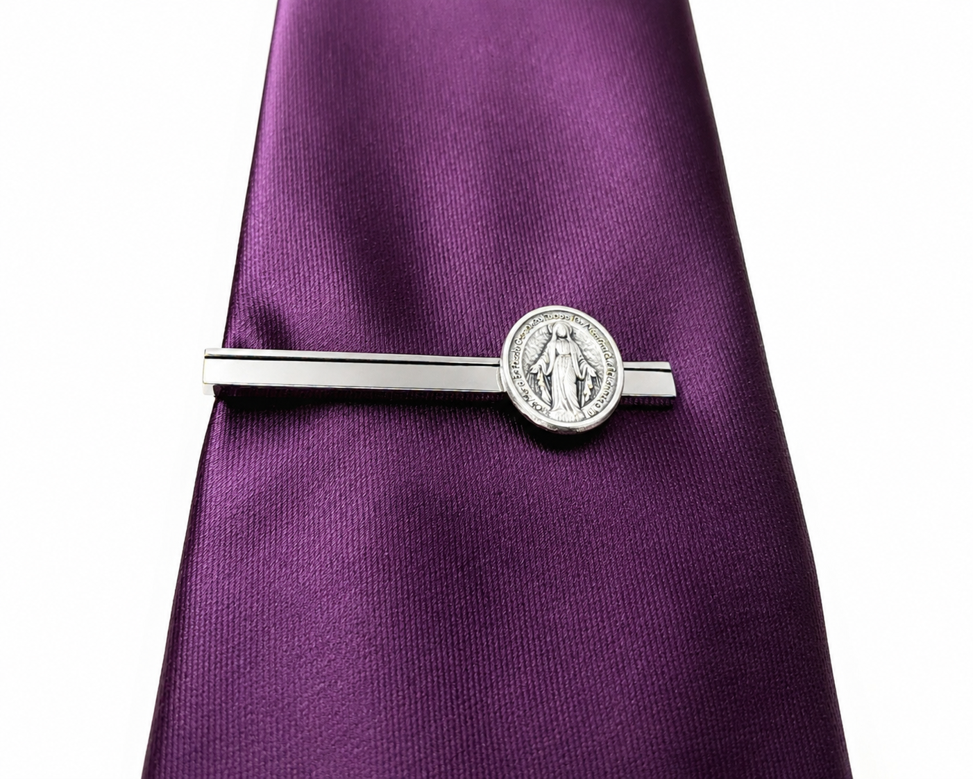 Silver tie clip on a purple tie against a white background Spanish Mother of Mary tie Clip