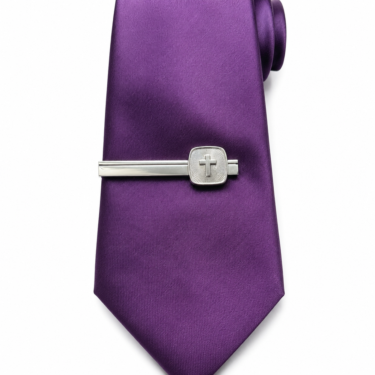 Purple tie with a silver tie clip featuring a cross on a white background