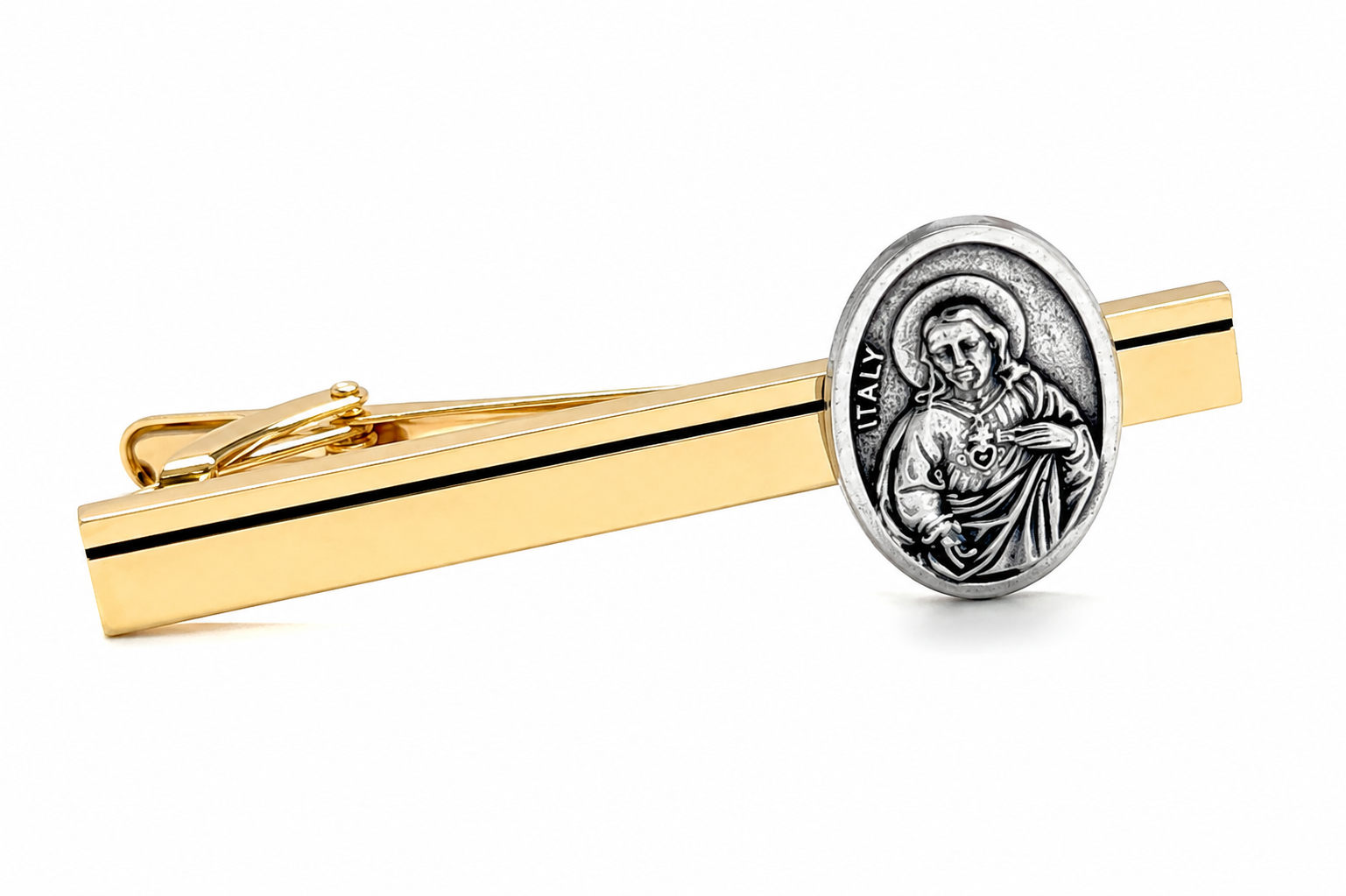 A gold tie bar featuring an oval silver-toned religious medallion depicting Jesus Christ with the word 'ITALY' on the bar, set against a plain white background.