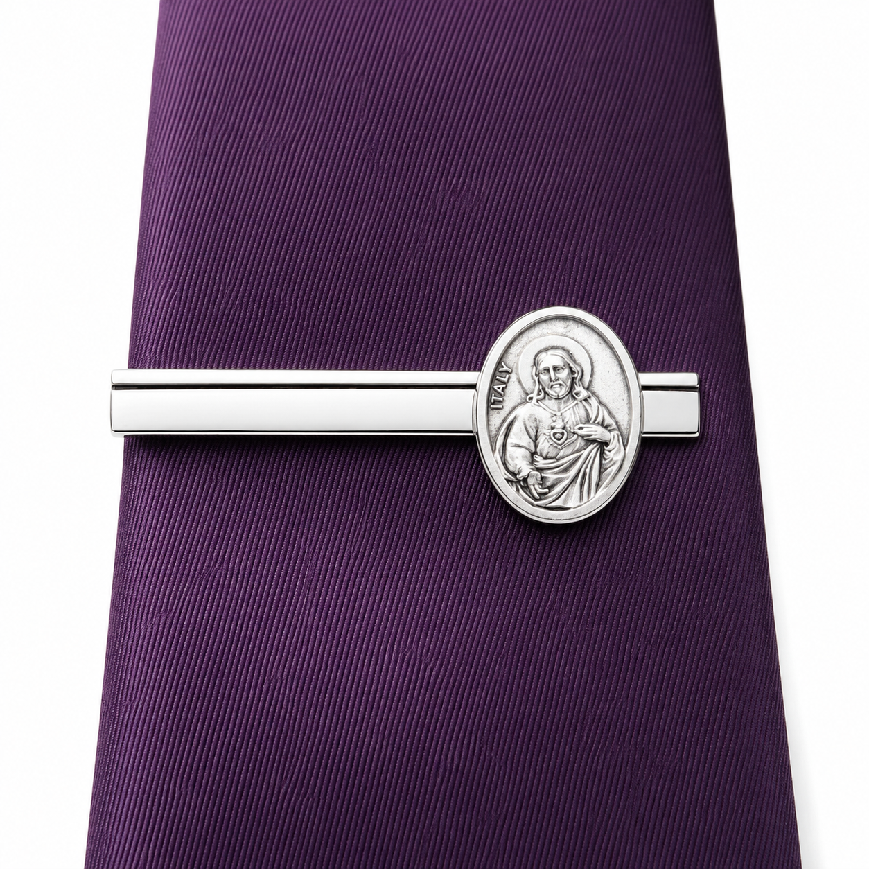 Silver tie clip with a religious design on a purple tie Detailed Sacred Heart of Jesus medallion on polished silver Christian tie clip