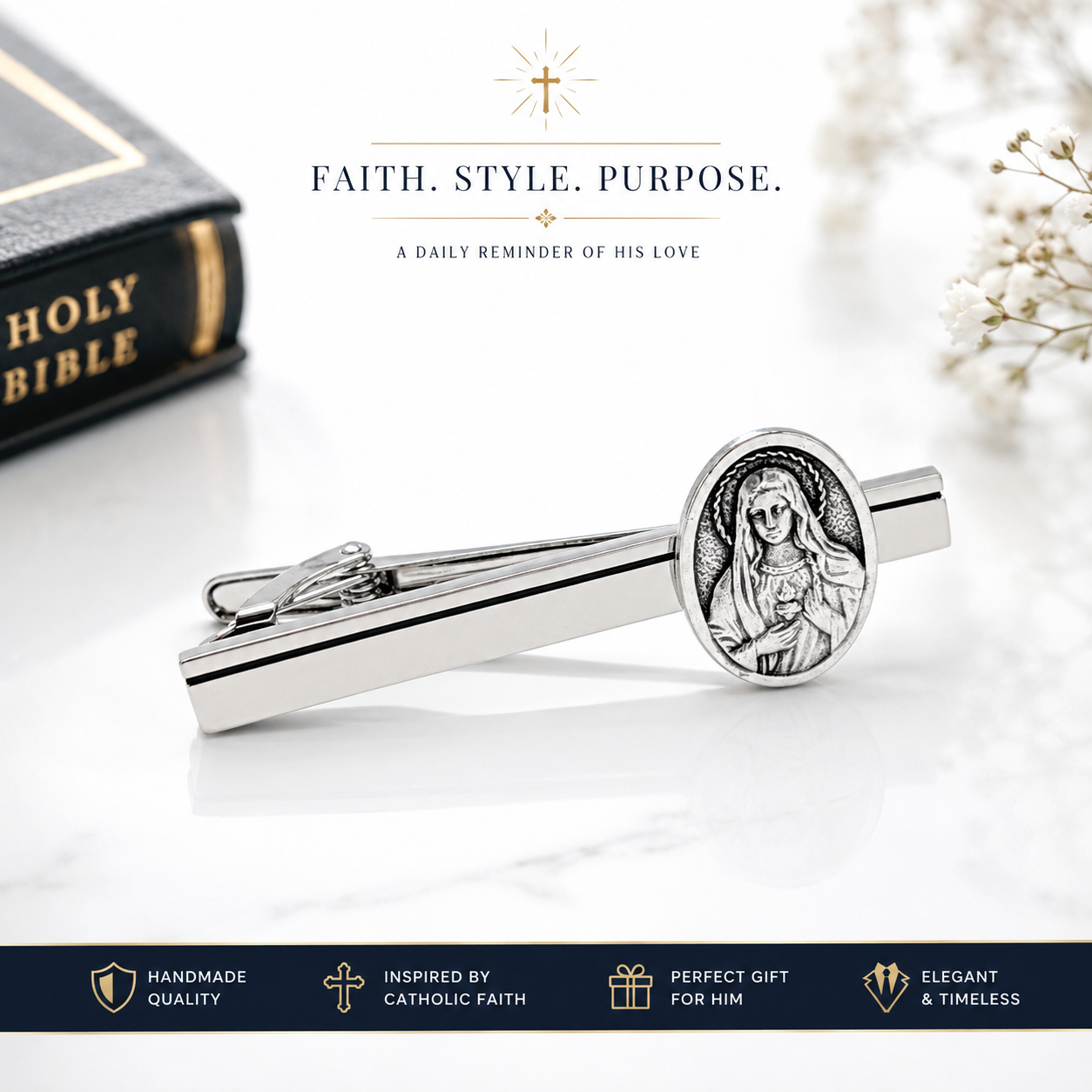 Silver tie clip with religious design on a white surface with a Bible in the background.