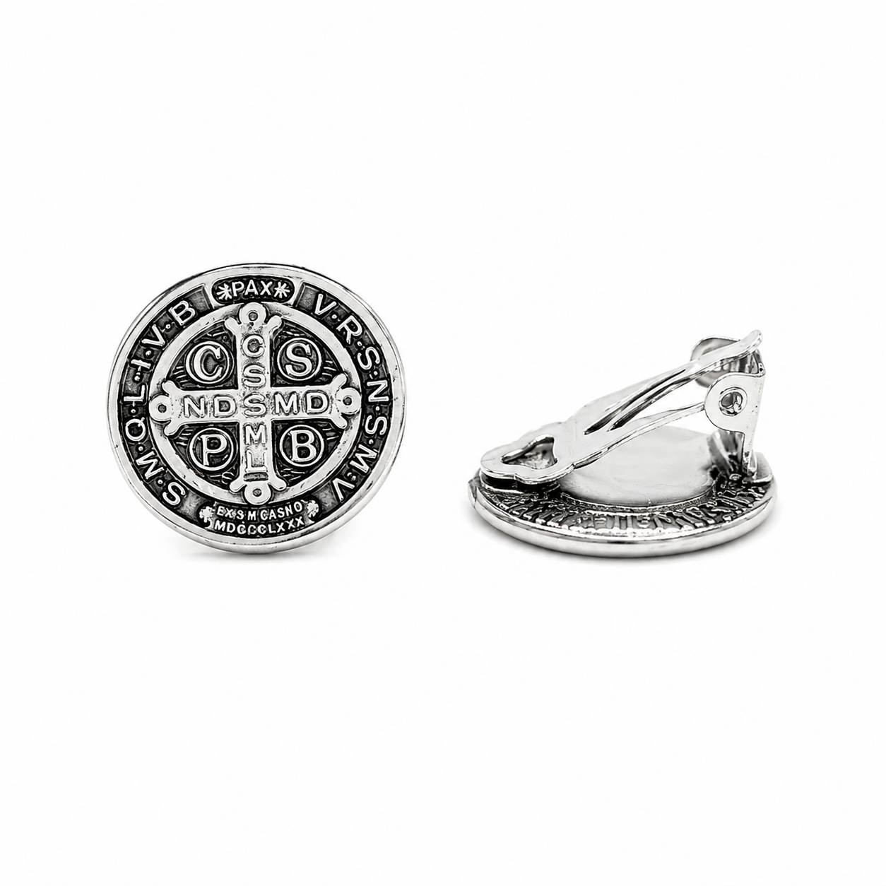 Silver Saint Benedict clip-on earrings with detailed Catholic medal design on a pure white background.