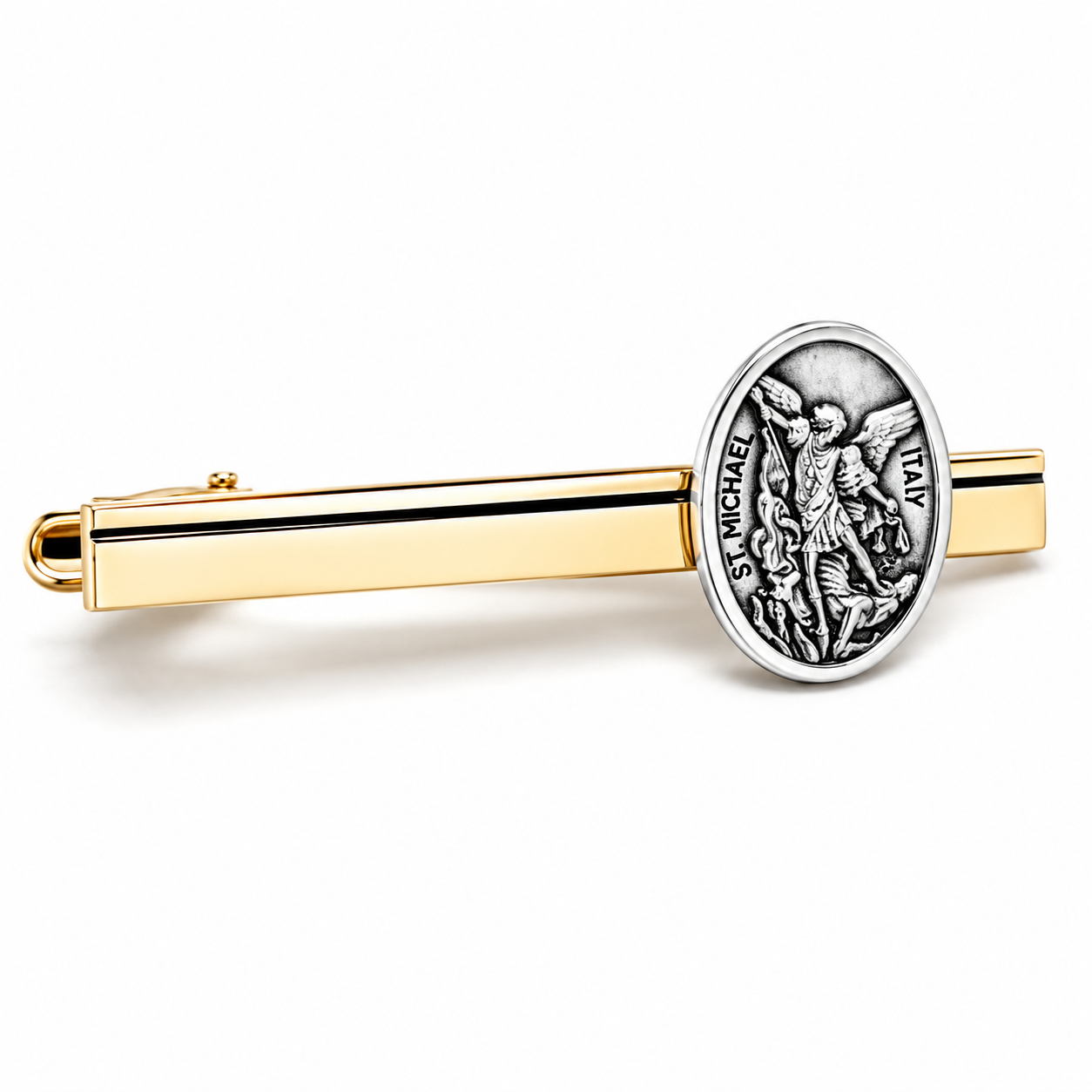 A gold tie bar featuring a circular silver-toned medallion of Saint Michael the Archangel, shown on a clean white background.