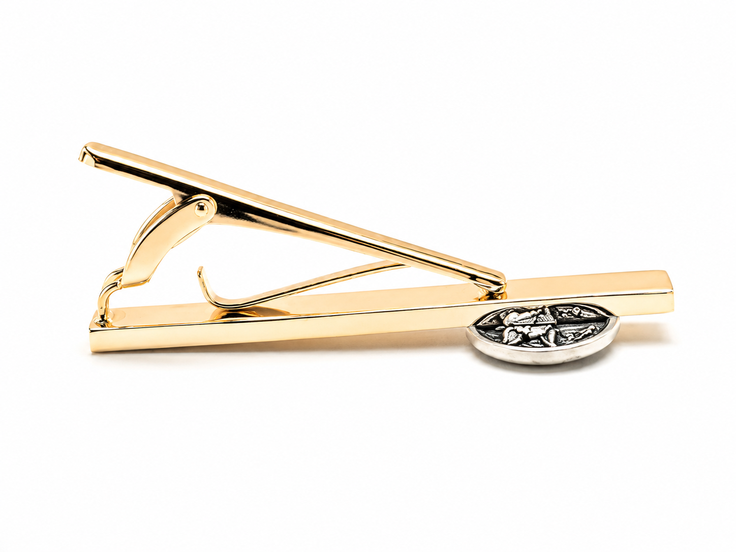 A gold tie clip with a silver oval accent featuring a floral engraving, shown on a plain white background.