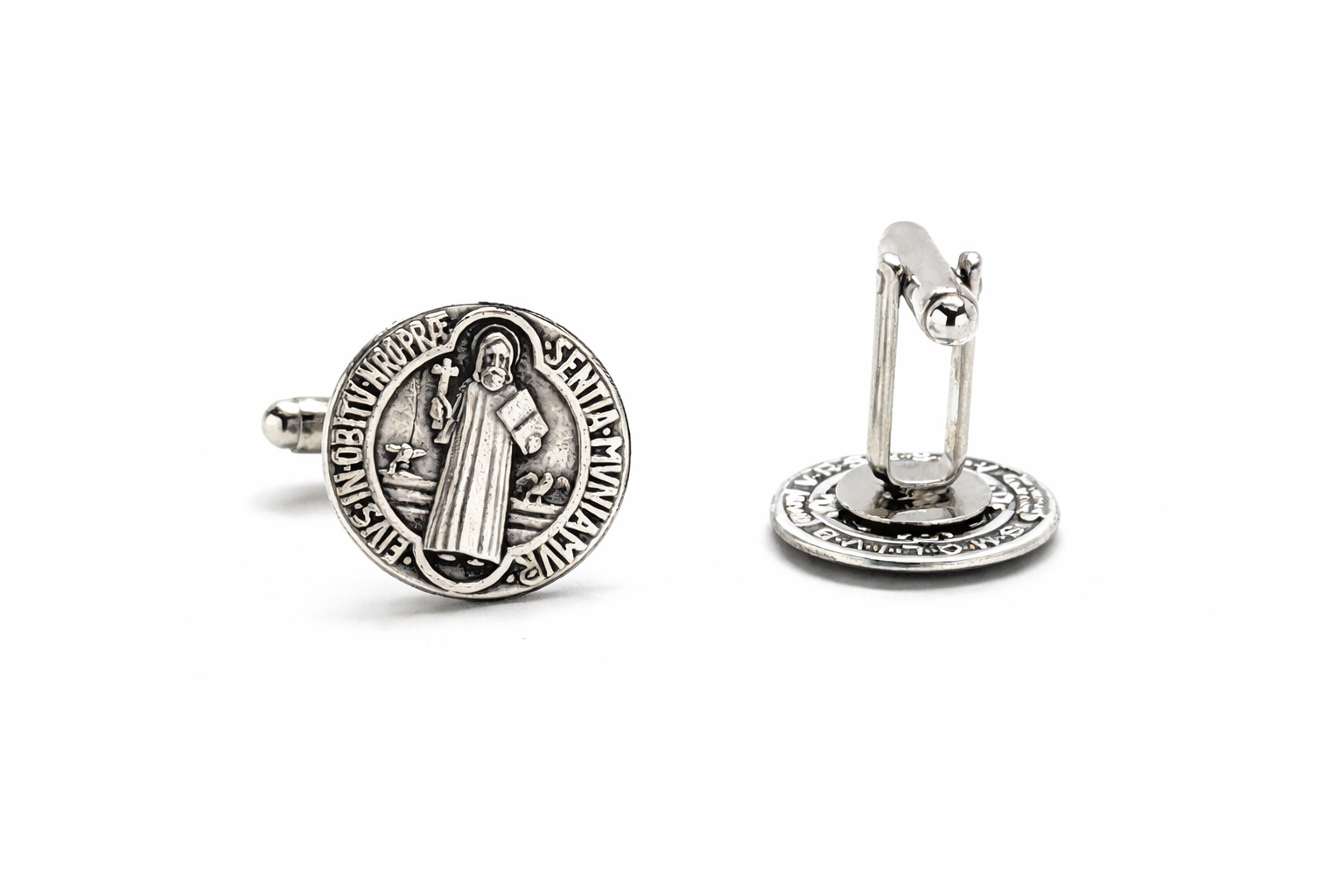 Close-up of a man in a crisp white French cuff shirt wearing St. Benedict's cufflinks, representing the Faithful Gentleman brand.