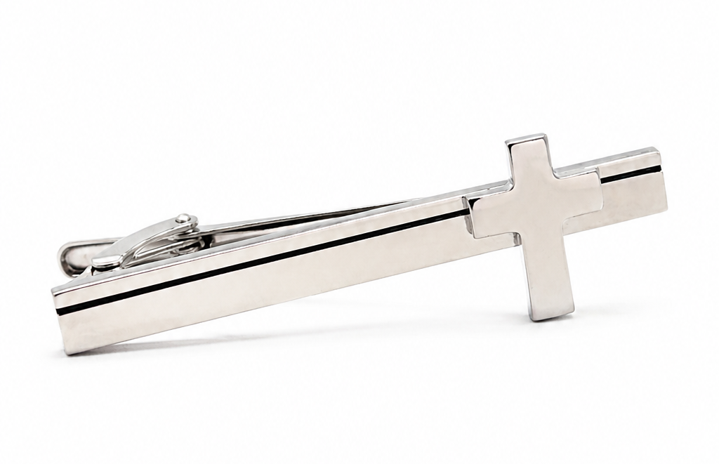 Silver cross-shaped tie clip on a white background