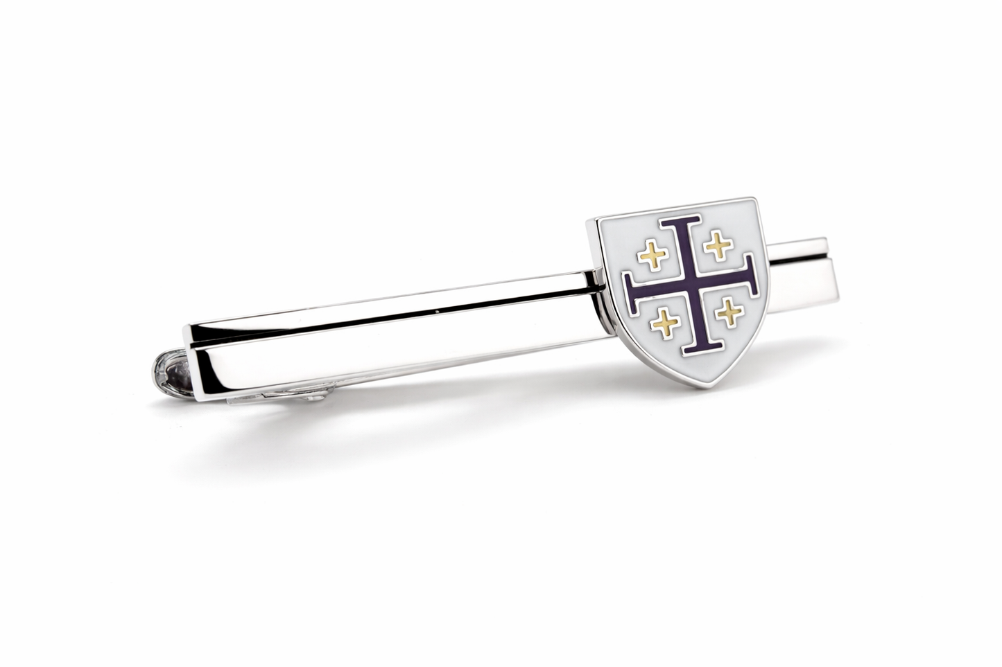 Silver tie clip with a shield design on a white background