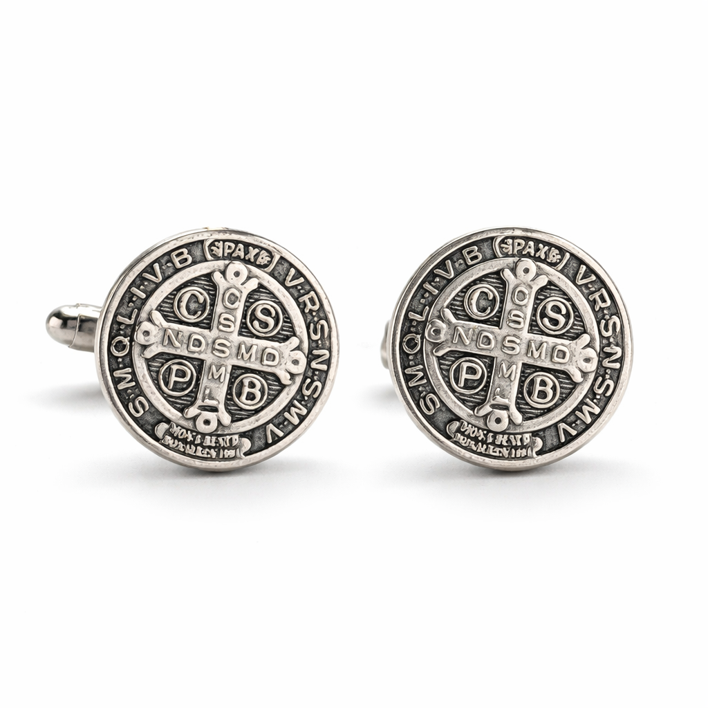 Pair of silver Saint Benedict's cross cufflinks on a white background