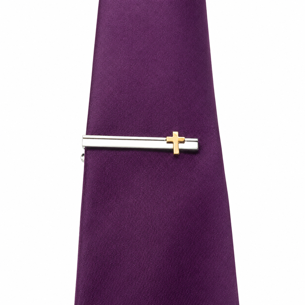 Purple tie with a silver and gold cross tie clip on a white background