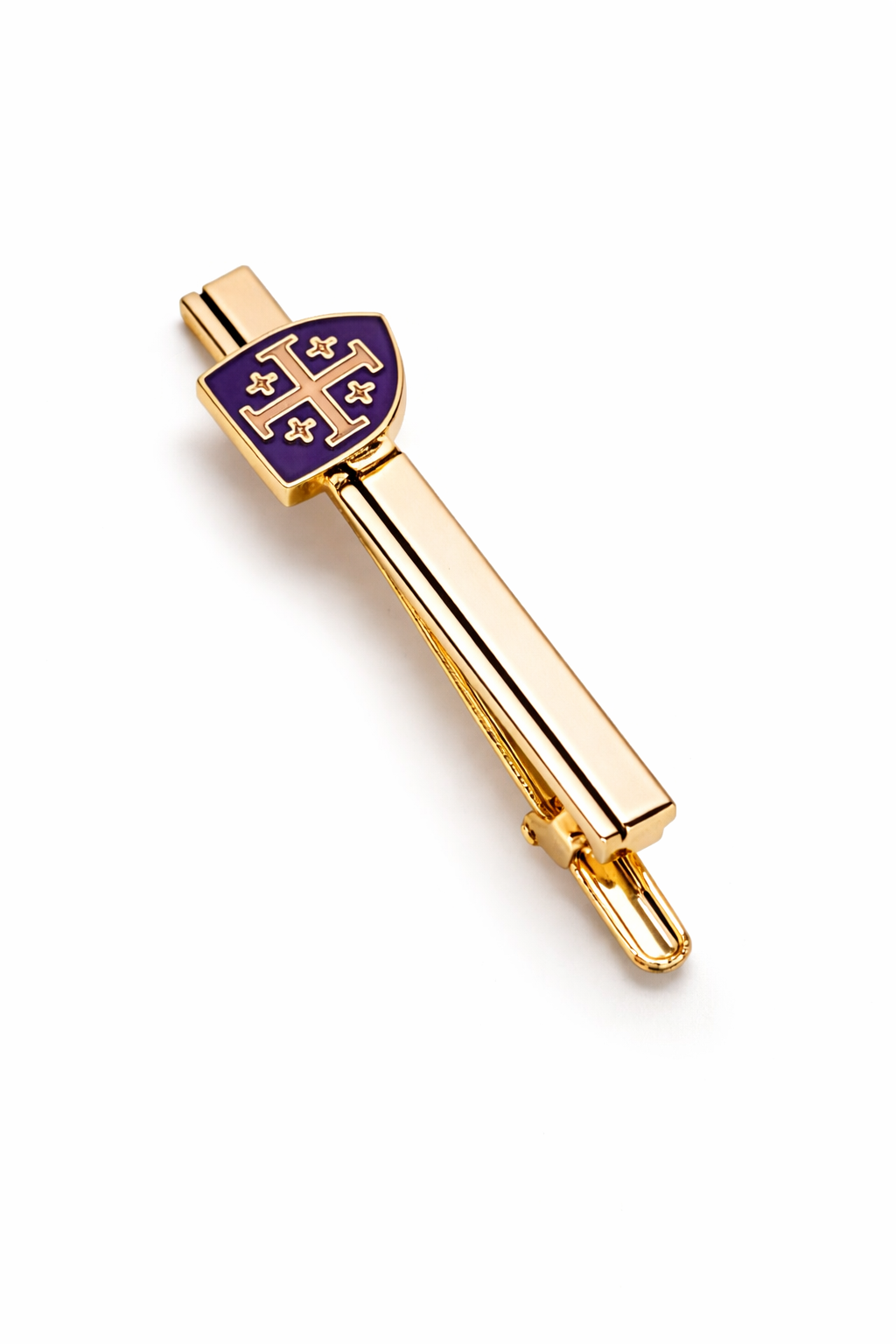 Gold tie clip with purple emblem on a white background